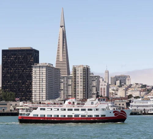 A ferry crossing the bay in front of the Transamerica Pyramid and the San Francisco waterfront